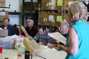 The driver having lunch with the crew before taking the load to the port!